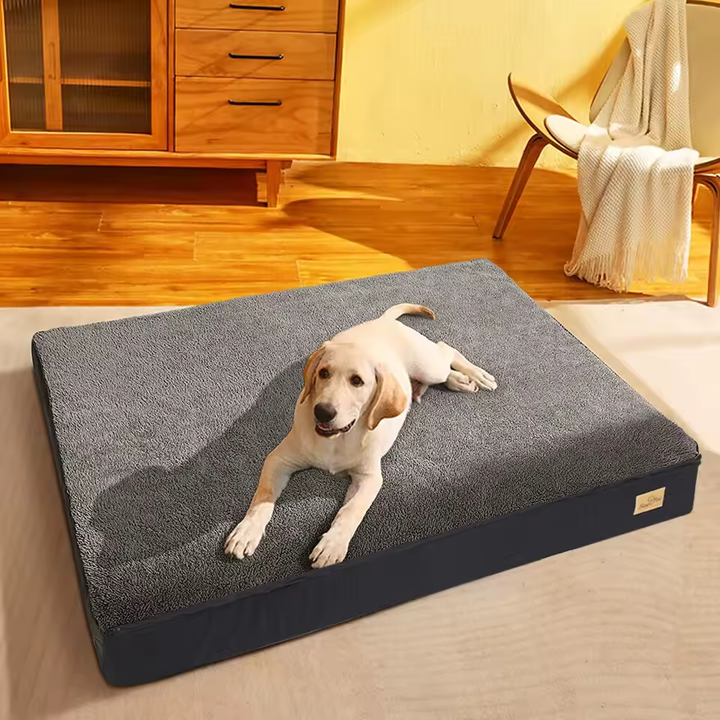 Flat gray plush-top dog mattress with dark sidewalls and no bolsters